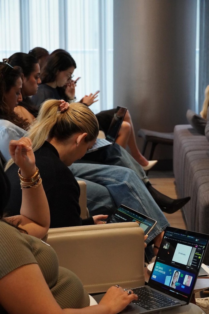 Attendees working through AI workflows on laptops